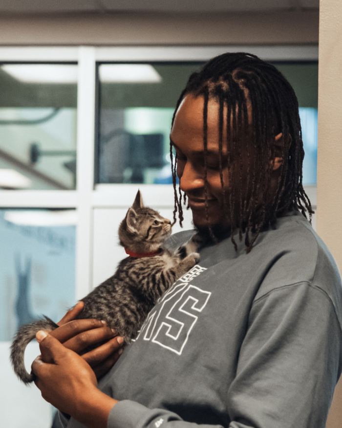 Myles holding a kitten from the Wisconsin Humane Society